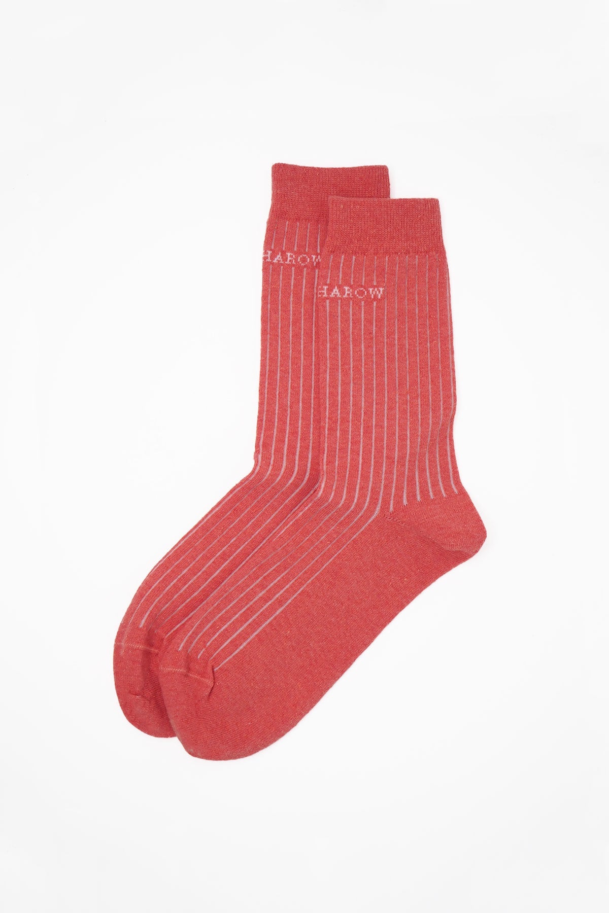 A pair of coral pink ribbed women's socks made from recycled materials, showcasing a stylish and eco-friendly design.