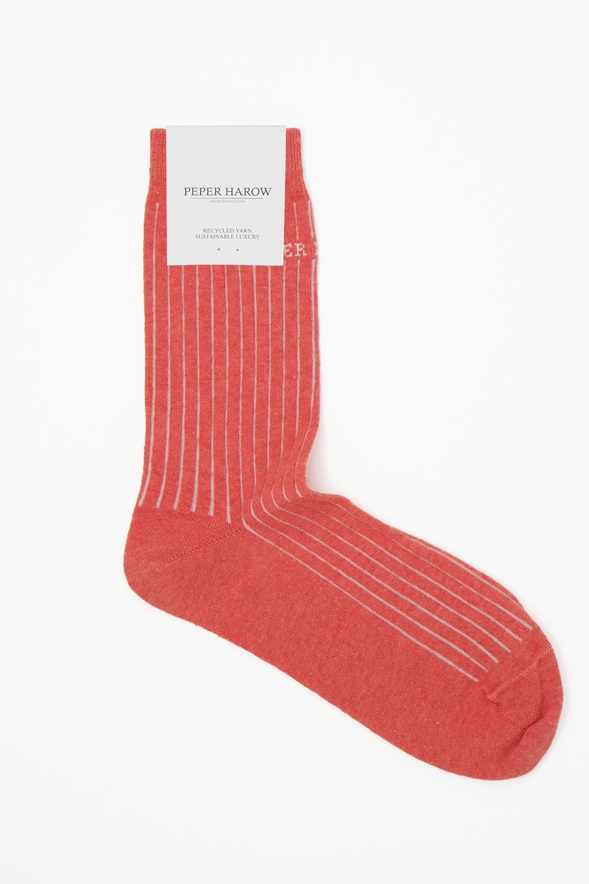 A pair of coral pink ribbed women's socks made from recycled materials, showcasing a stylish and eco-friendly design.