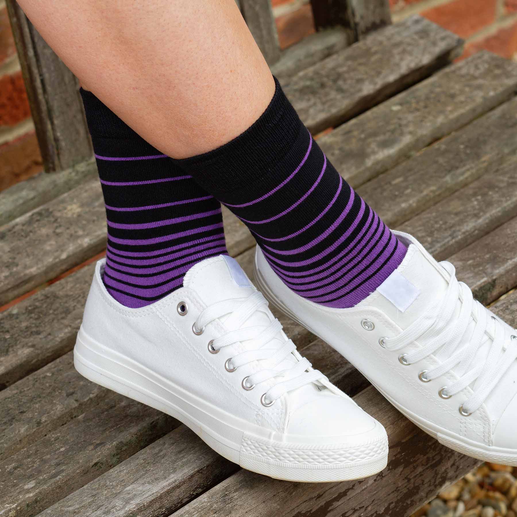 A pair of Retro Stripe Women's Socks in purple with contrasting black stripes, showcasing luxury and style.