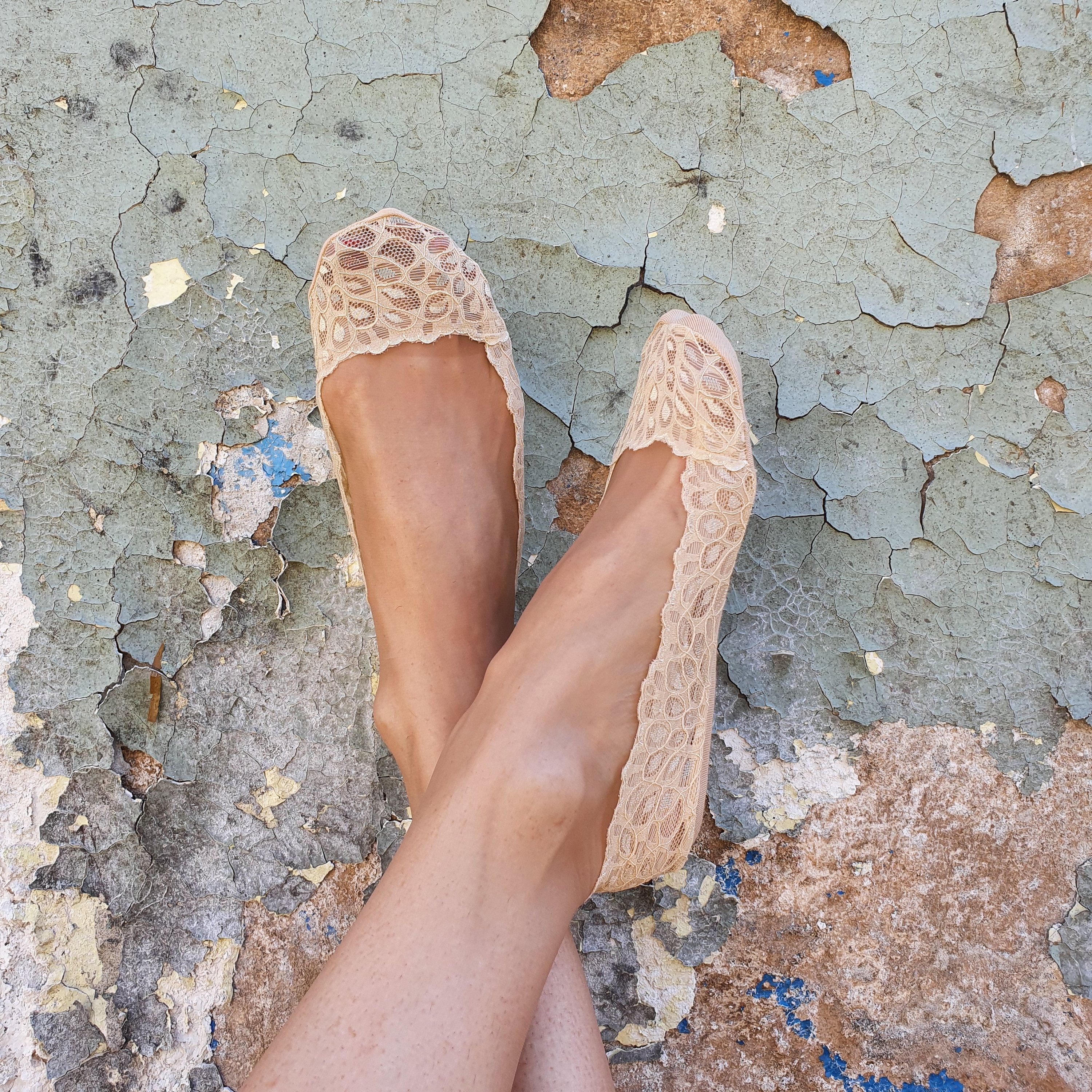 RICCA beige footsies featuring a lace pattern and silicone grip for comfort.