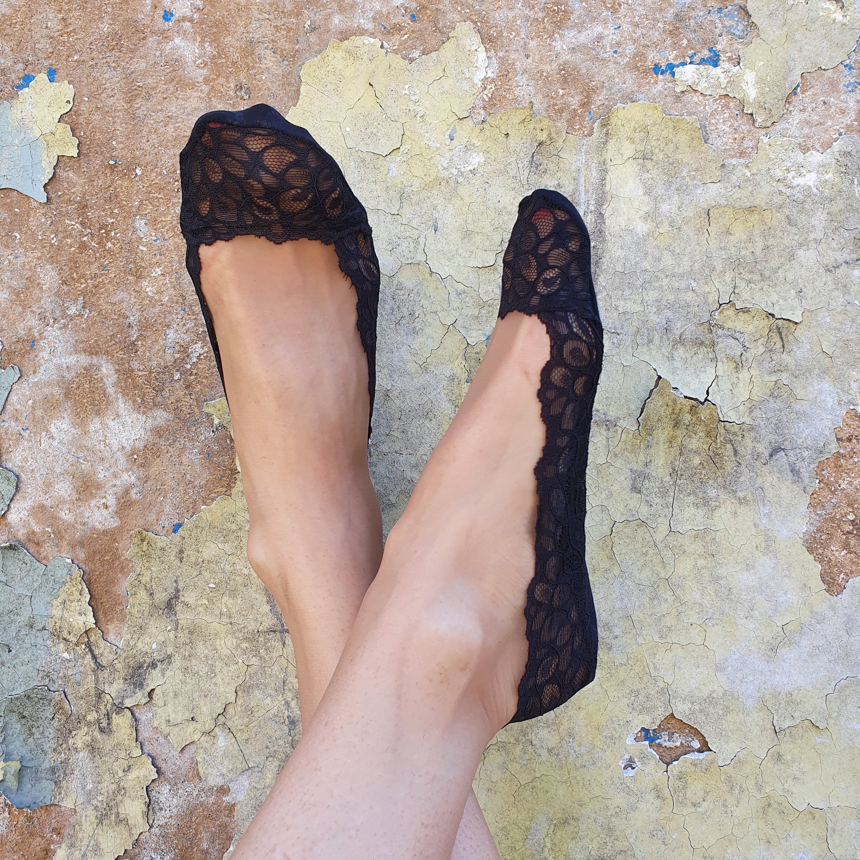 RICCA black footsies featuring a lace pattern and silicone inner layer for comfort and secure fit.