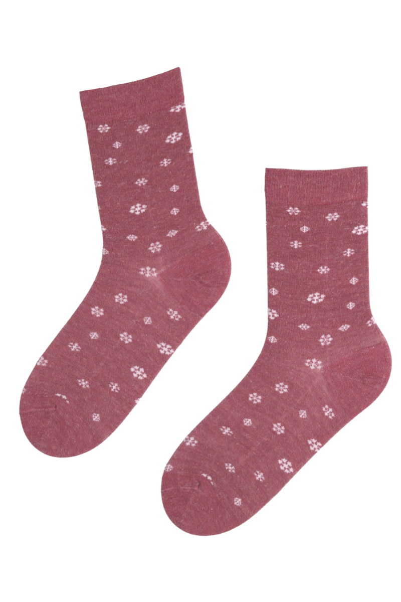 SNOWSTORM pink angora wool socks with white snowflakes on a pink background, showcasing their soft texture and cozy design.