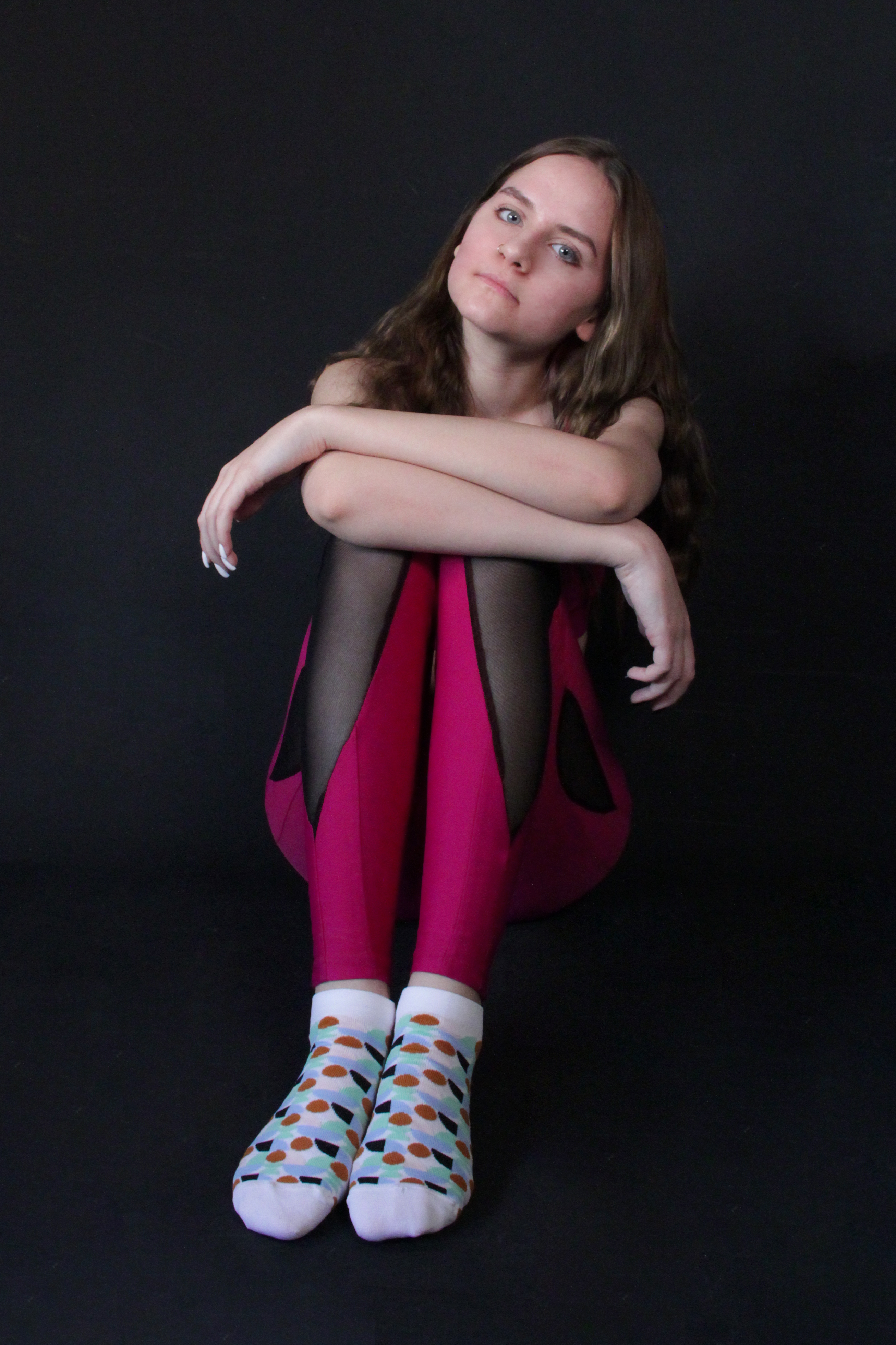 person sitting, wearing patterned socks