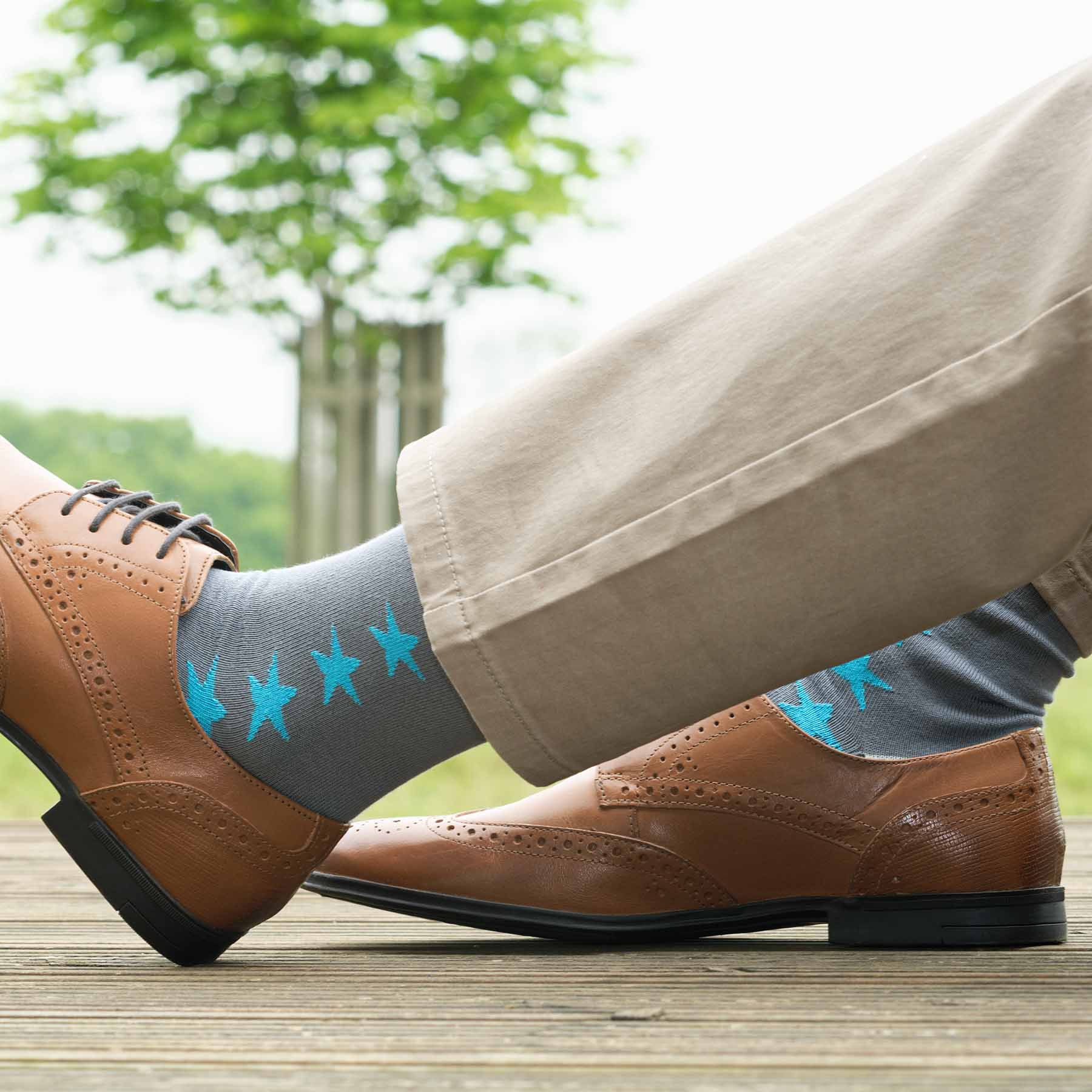 Starfall Men's Socks in grey with contrasting blue stars, showcasing luxury and style.