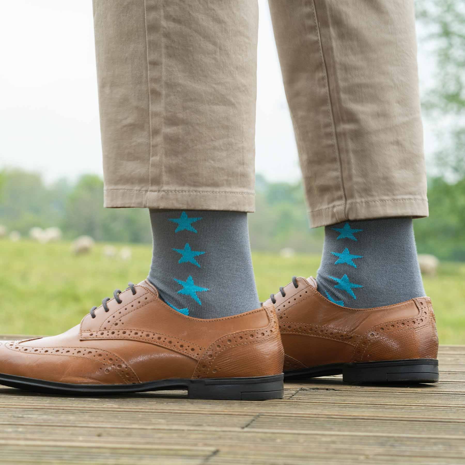 Starfall Men's Socks in grey with contrasting blue stars, showcasing luxury and style.