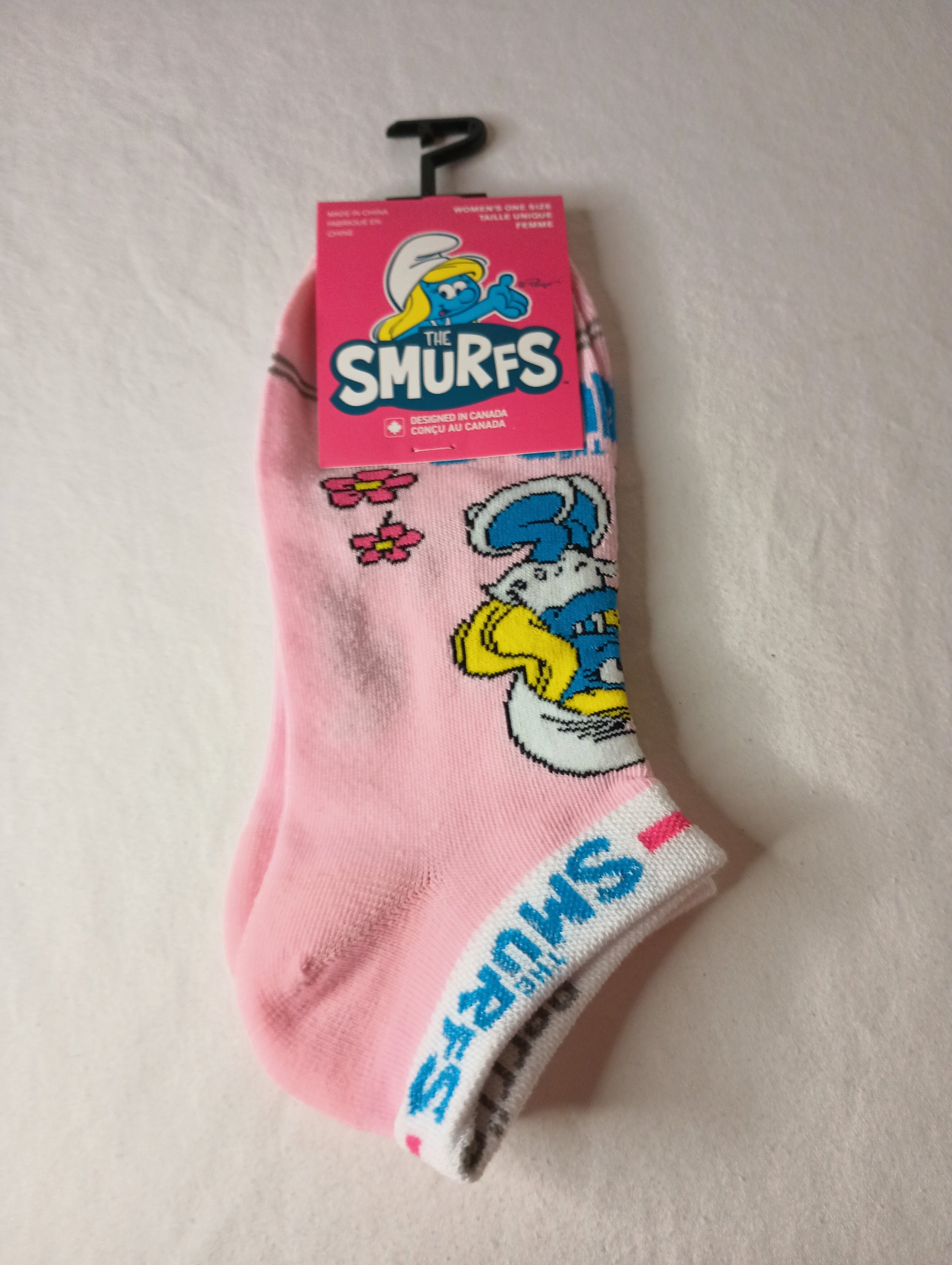 A pair of pink multi The Smurfs ankle socks featuring colorful designs of Smurfs characters, suitable for women's shoe sizes 6-9.5.