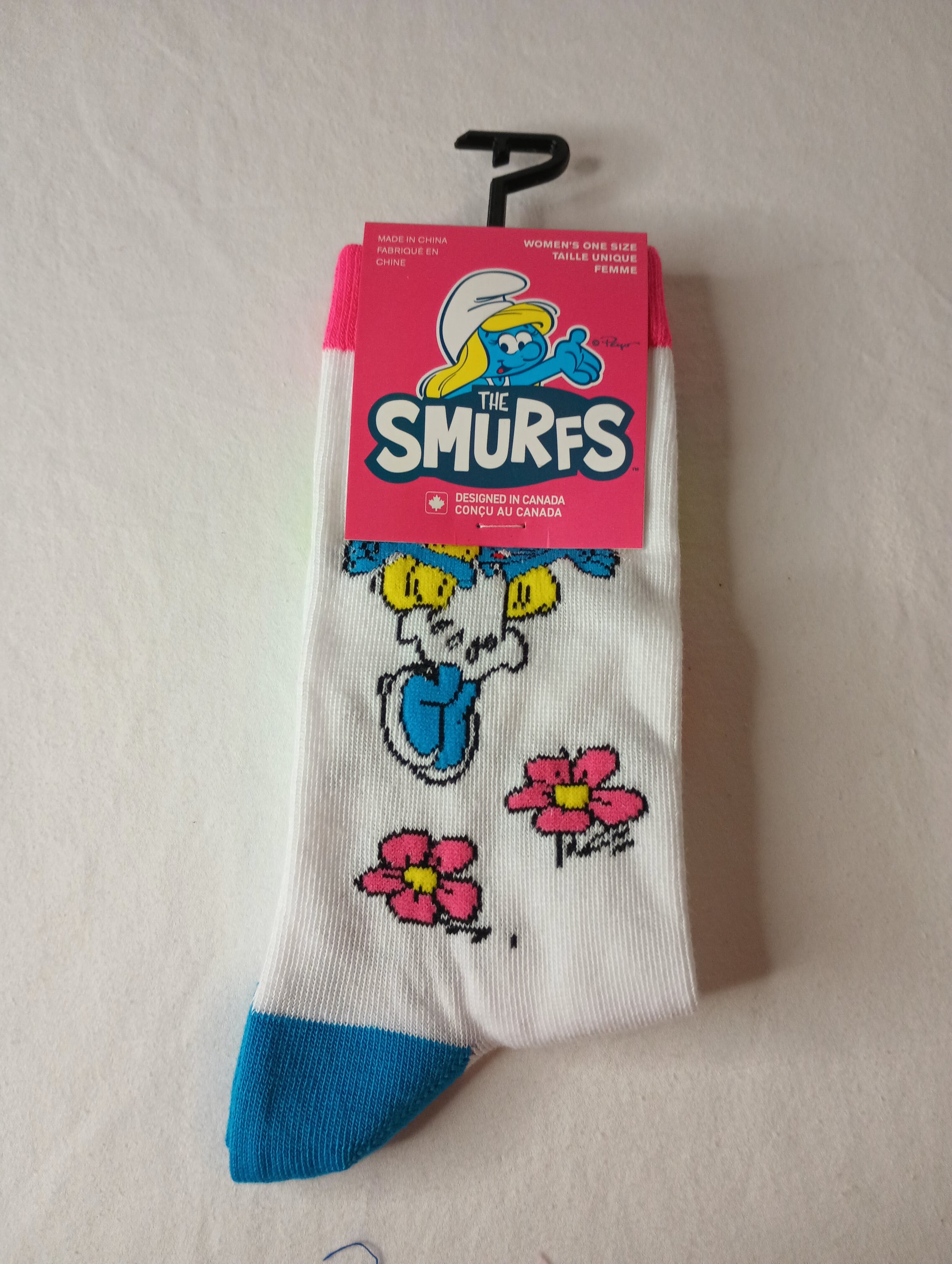 A pair of colorful The Smurfs Crew Socks featuring vibrant designs on a white background, suitable for women's shoe sizes 6-9.5.