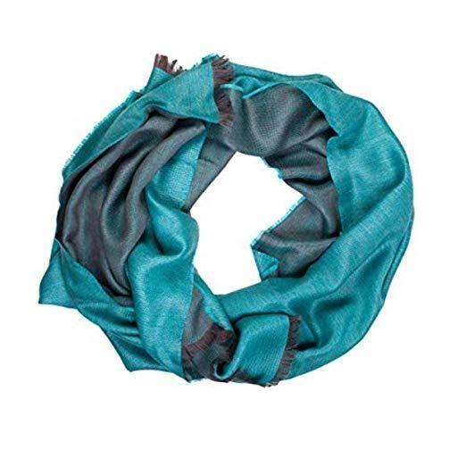 Turquoise double face alpaca wool and silk shawl elegantly draped, showcasing its luxurious texture and vibrant color.