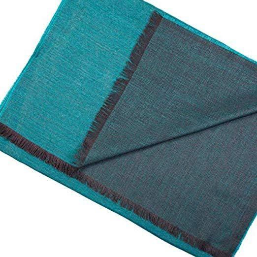 Turquoise double face alpaca wool and silk shawl elegantly draped, showcasing its luxurious texture and vibrant color.