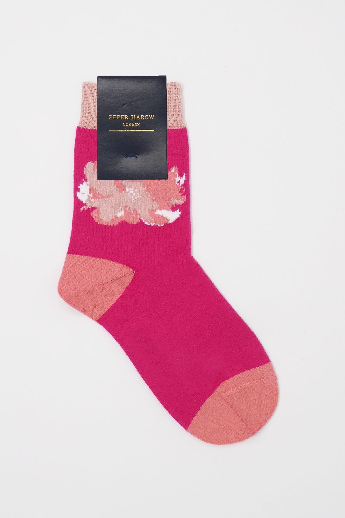 A pair of Wild Flower Women's Socks in Rose featuring vibrant pinks, warm peaches, and delicate whites, made from soft Supima cotton.