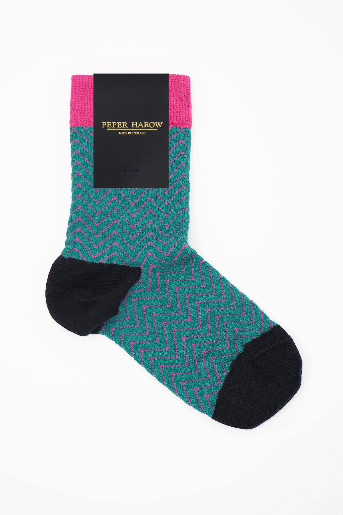 A pair of vibrant teal Zigzag women's socks featuring a stylish zigzag pattern in bright pink, made from luxurious Supima cotton.