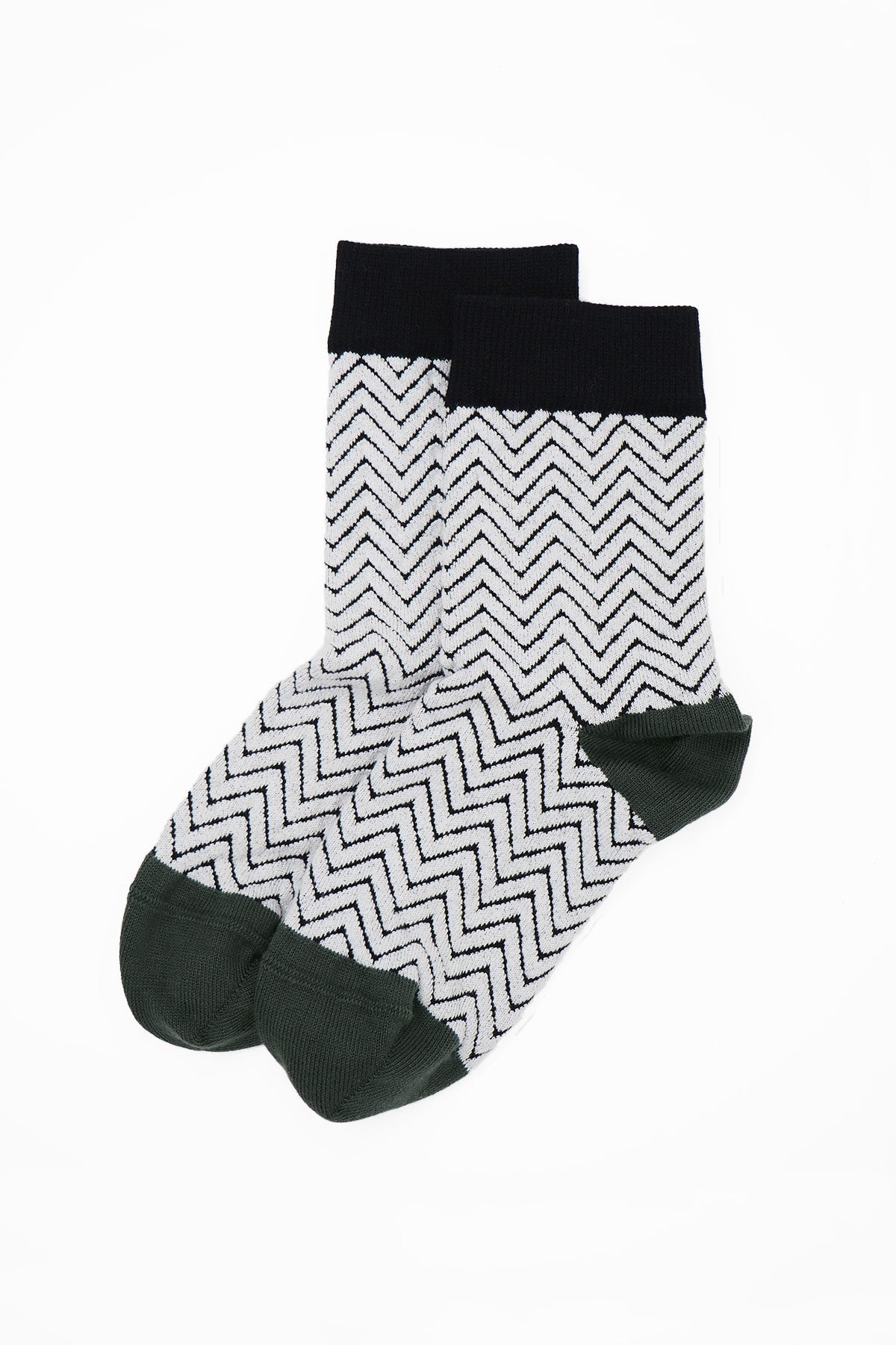 A pair of stylish white Zigzag women's socks featuring a chic black zigzag pattern, made from luxurious Supima cotton.