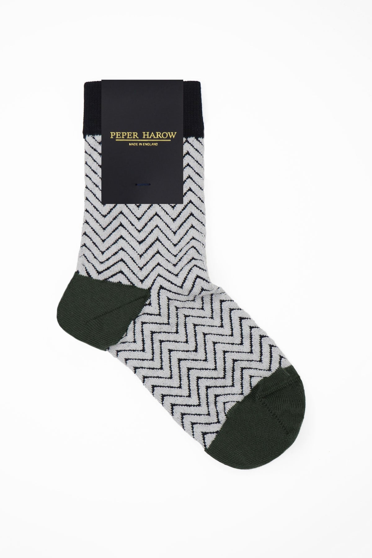 A pair of stylish white Zigzag women's socks featuring a chic black zigzag pattern, made from luxurious Supima cotton.