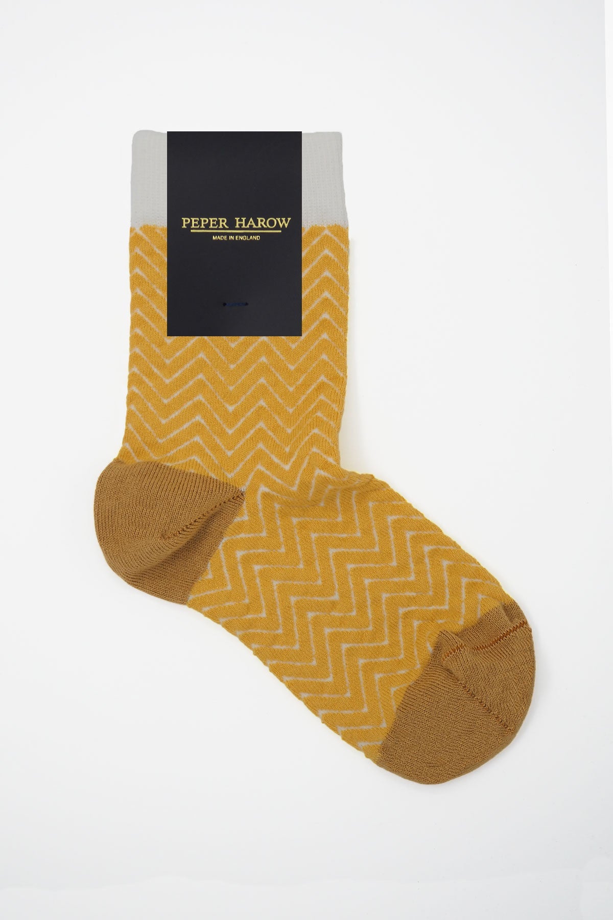 A pair of vibrant yellow and white Zigzag women's socks made from luxurious Supima cotton, showcasing a stylish design.