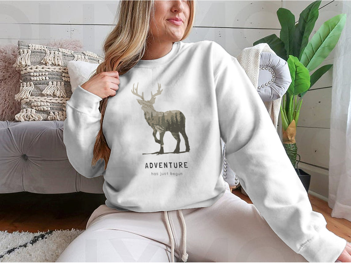 Adventure Slogan T-shirt featuring an alpine mountain view and deer silhouette, showcasing a stylish outdoor design.