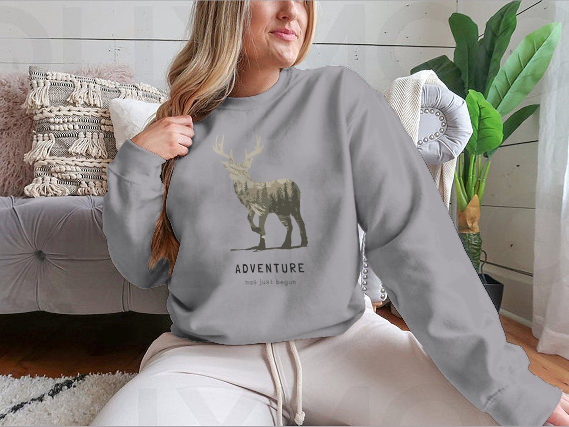 Adventure Slogan T-shirt featuring an alpine mountain view and deer silhouette, showcasing a stylish outdoor design.