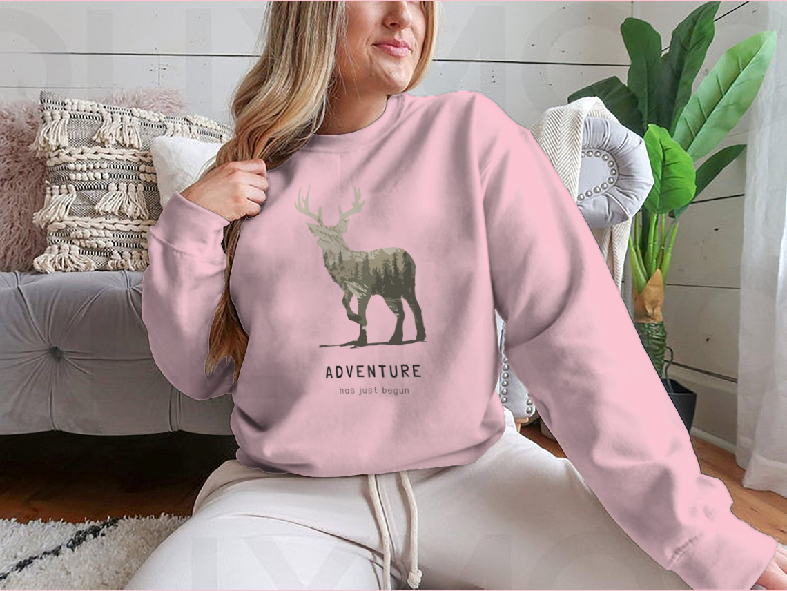 Adventure Slogan T-shirt featuring an alpine mountain view and deer silhouette, showcasing a stylish outdoor design.