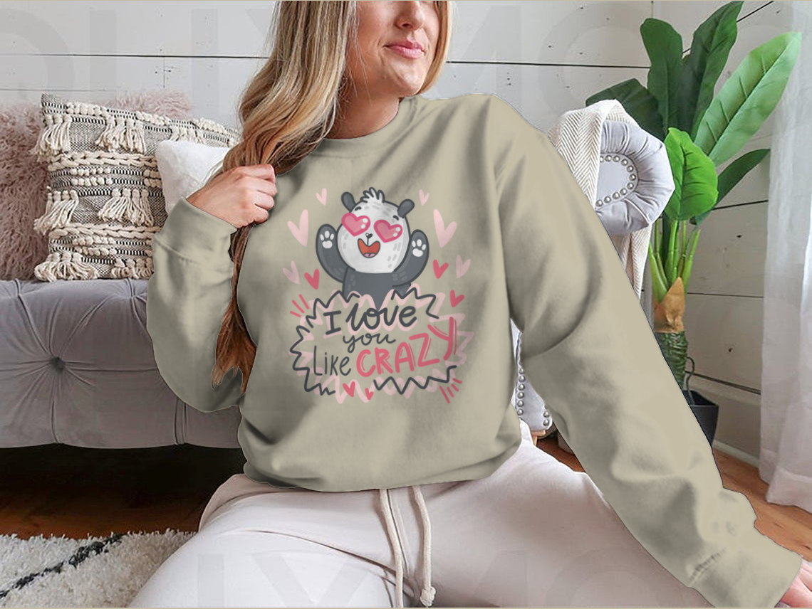 A cute panda character surrounded by hearts and playful lettering, showcasing a whimsical design perfect for casual wear.