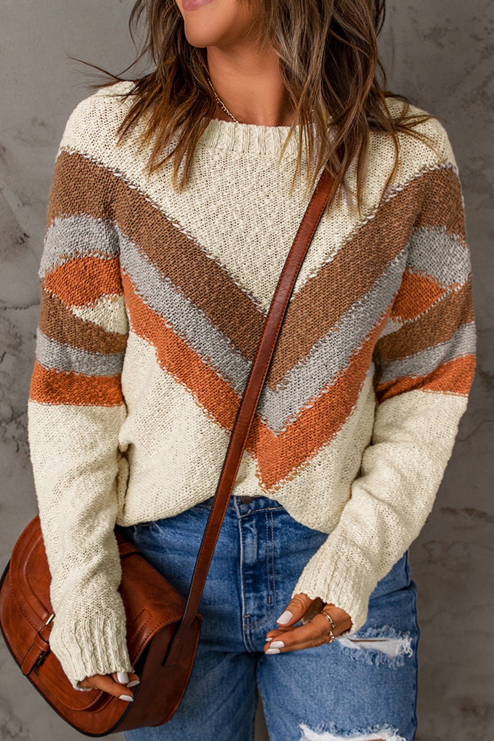 A stylish beige sweater featuring a trendy chevron striped pattern, perfect for winter wear, with ribbed trim and drop shoulder design.