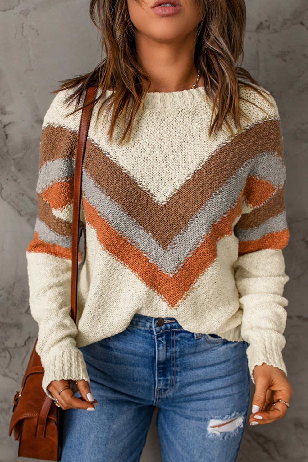 A stylish beige sweater featuring a trendy chevron striped pattern, perfect for winter wear, with ribbed trim and drop shoulder design.