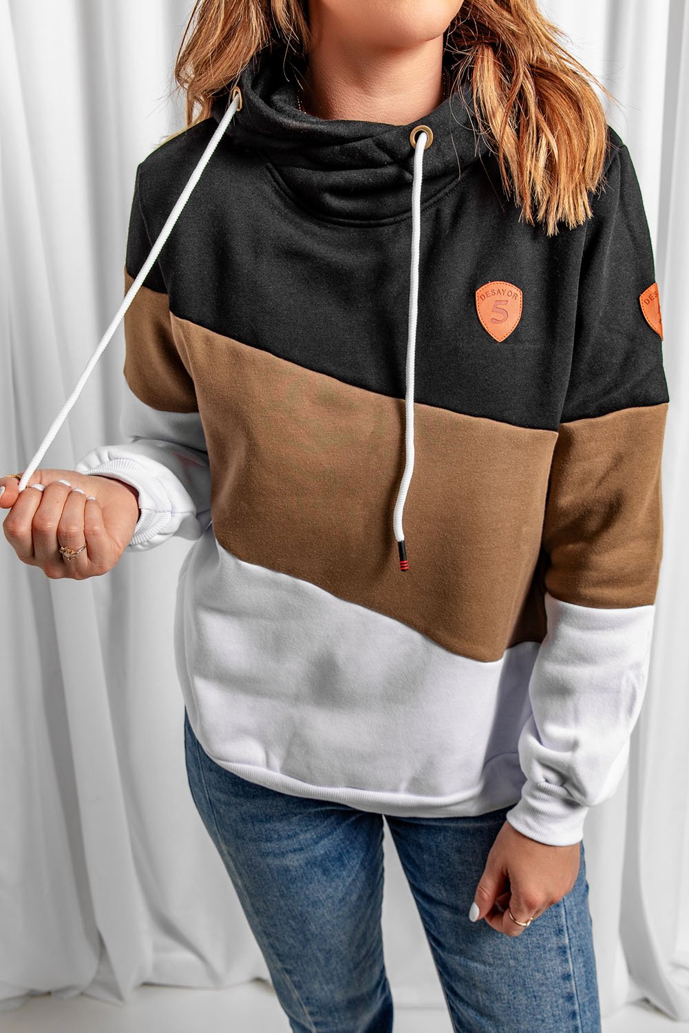 A stylish black colorblock hoodie featuring a hood, full sleeves, and a trendy design, perfect for casual and sporty occasions.