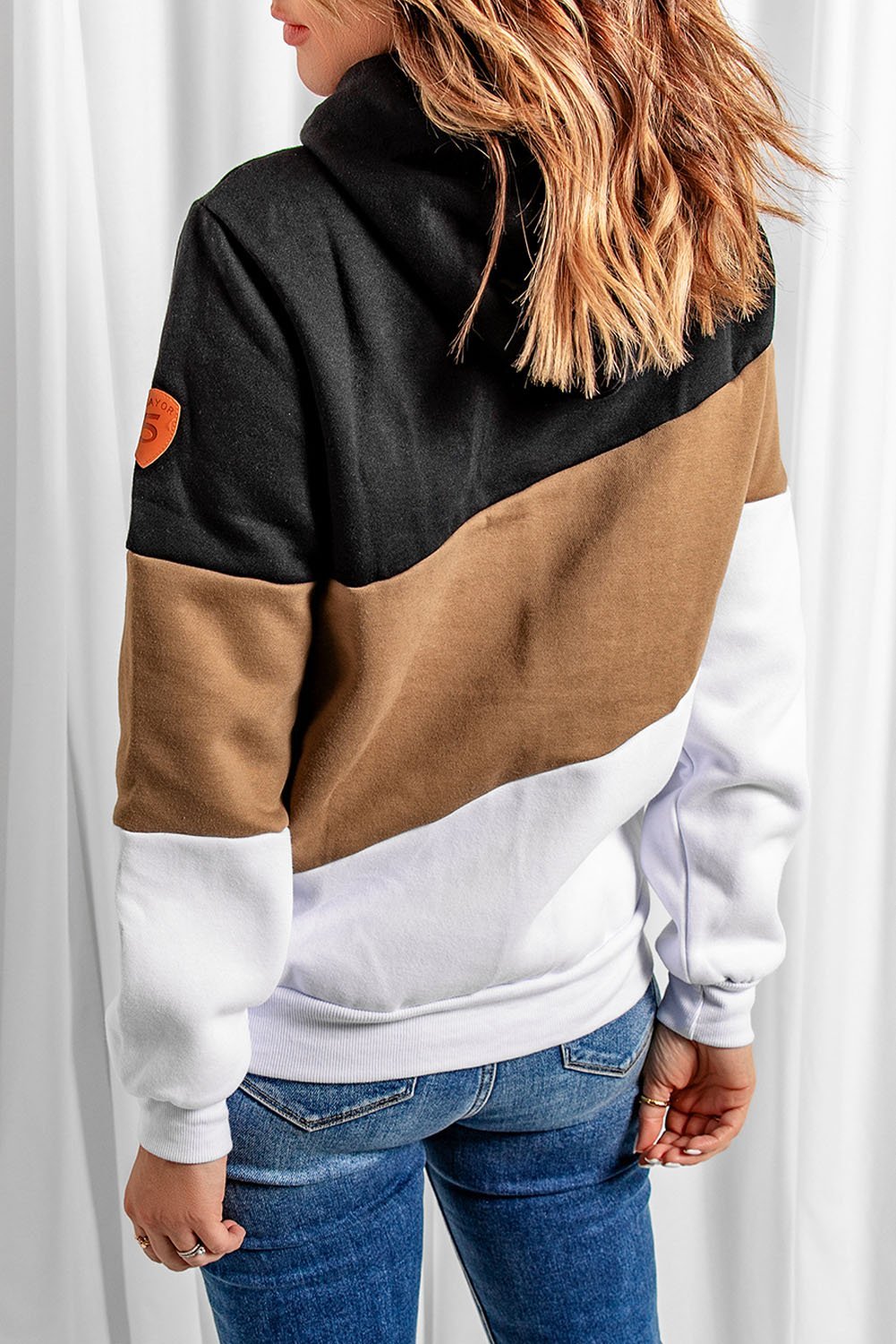 A stylish black colorblock hoodie featuring a hood, full sleeves, and a trendy design, perfect for casual and sporty occasions.