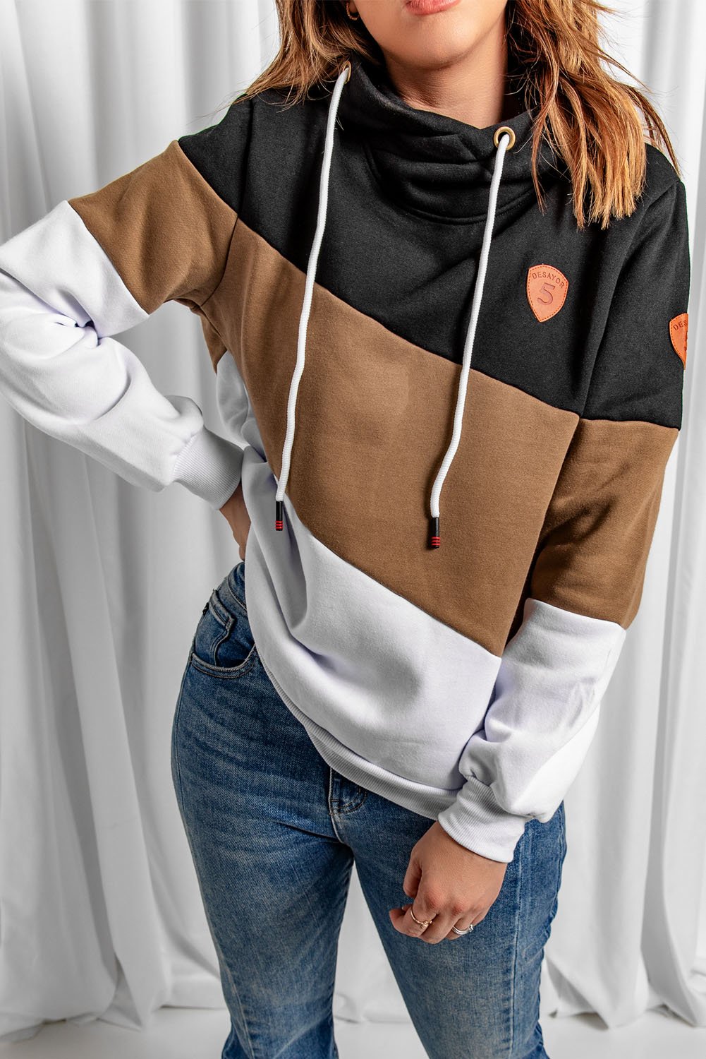 A stylish black colorblock hoodie featuring a hood, full sleeves, and a trendy design, perfect for casual and sporty occasions.