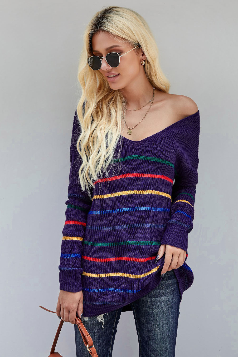 A cozy blue striped loose knit sweater displayed on a mannequin, showcasing its casual style and full sleeves.