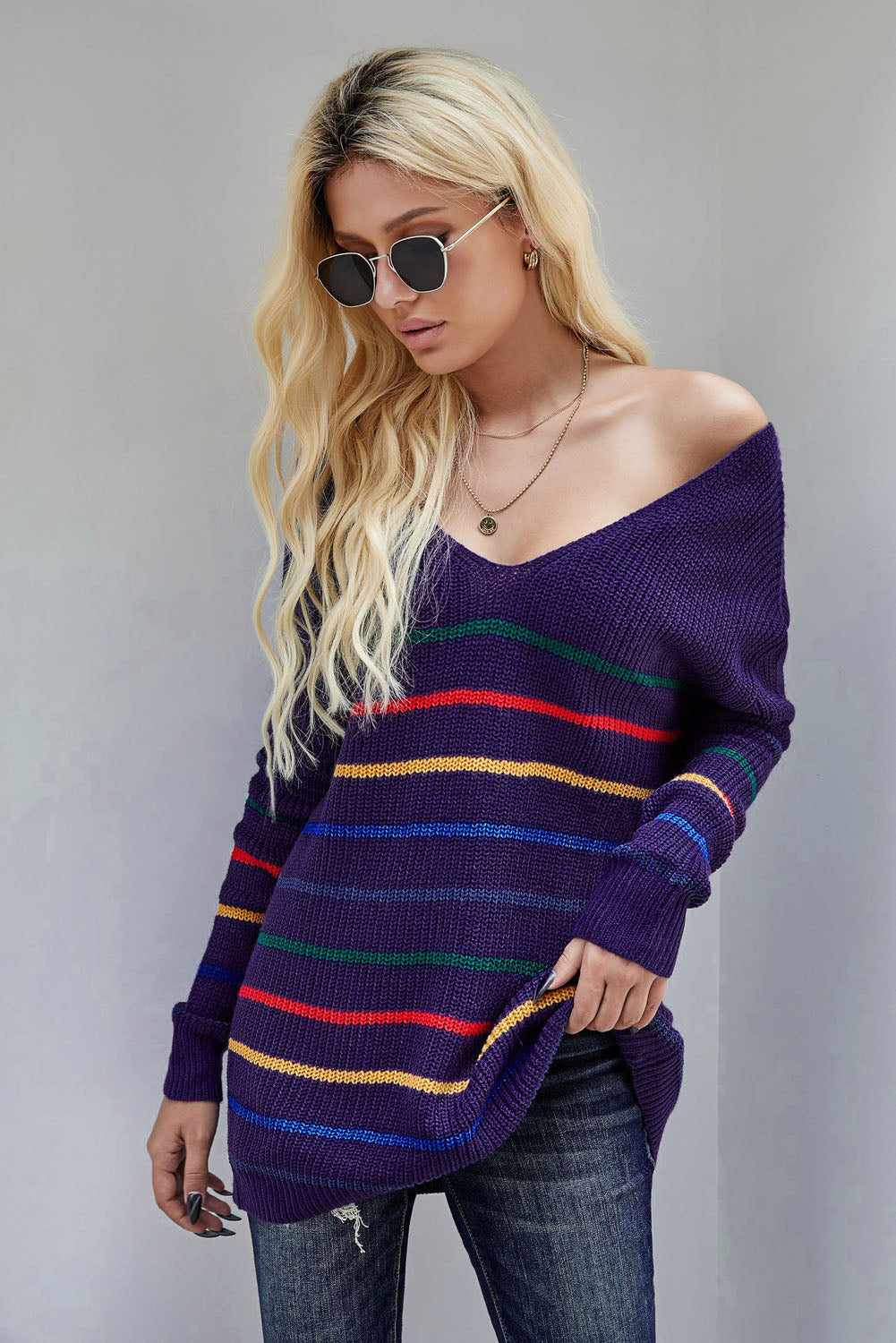 A cozy blue striped loose knit sweater displayed on a mannequin, showcasing its casual style and full sleeves.