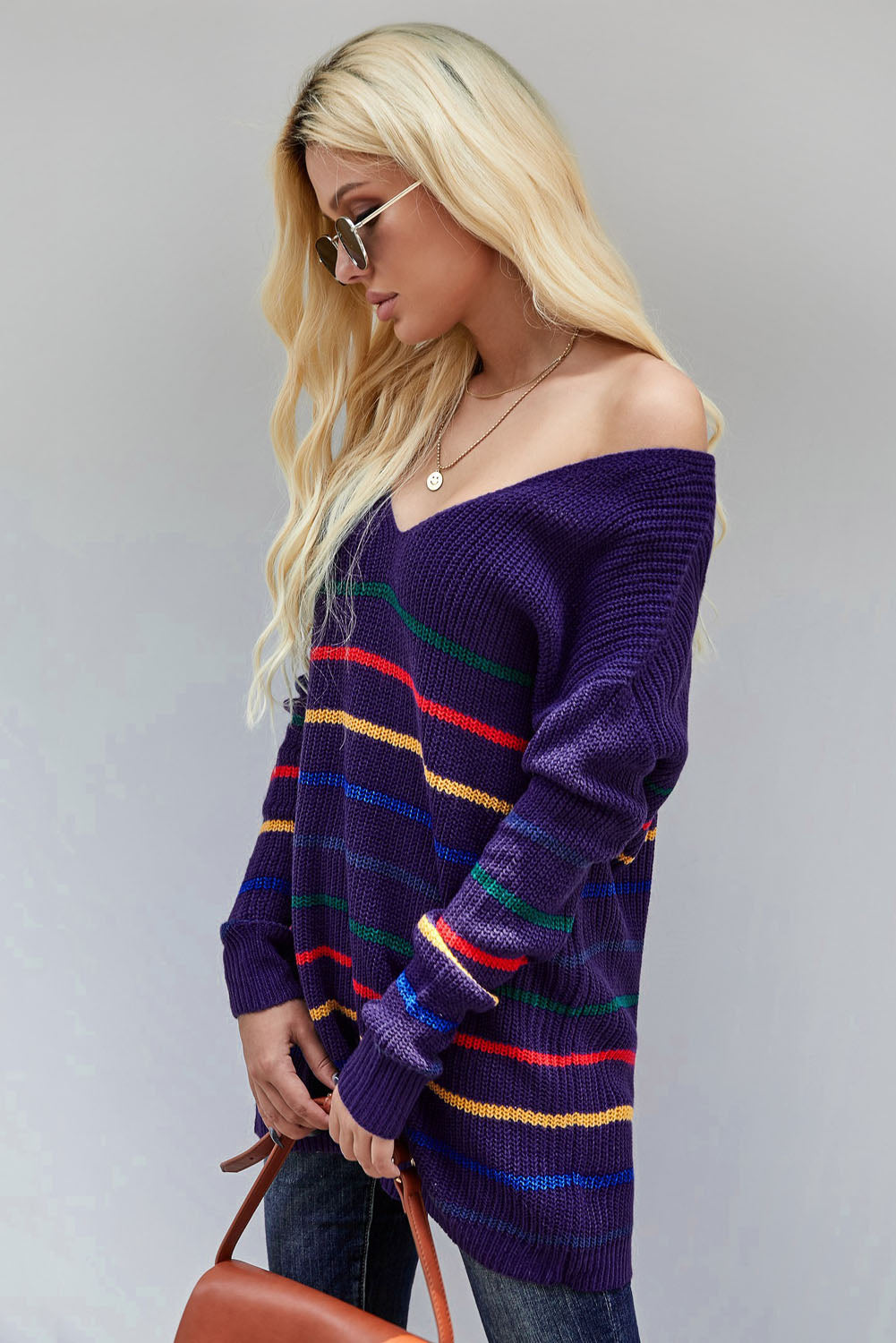 A cozy blue striped loose knit sweater displayed on a mannequin, showcasing its casual style and full sleeves.