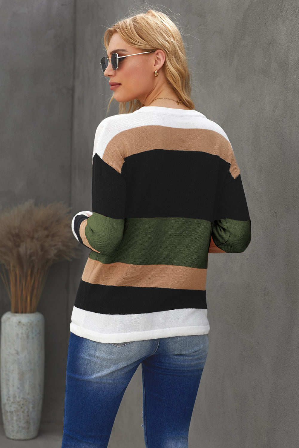 Casual green and black colorblock knit sweater featuring a round neck and full sleeves, perfect for a stylish and comfortable look.