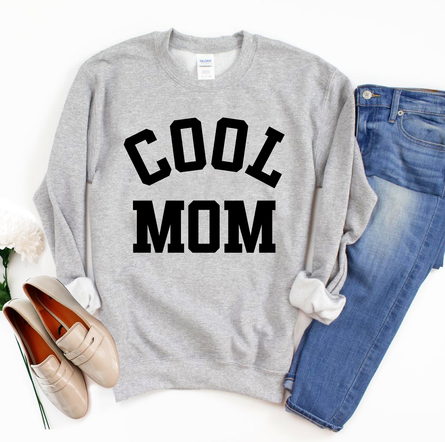 A stylish Cool Mom Sweatshirt in a cozy fabric, featuring a crew neck and rib-knit collar, perfect for casual wear.