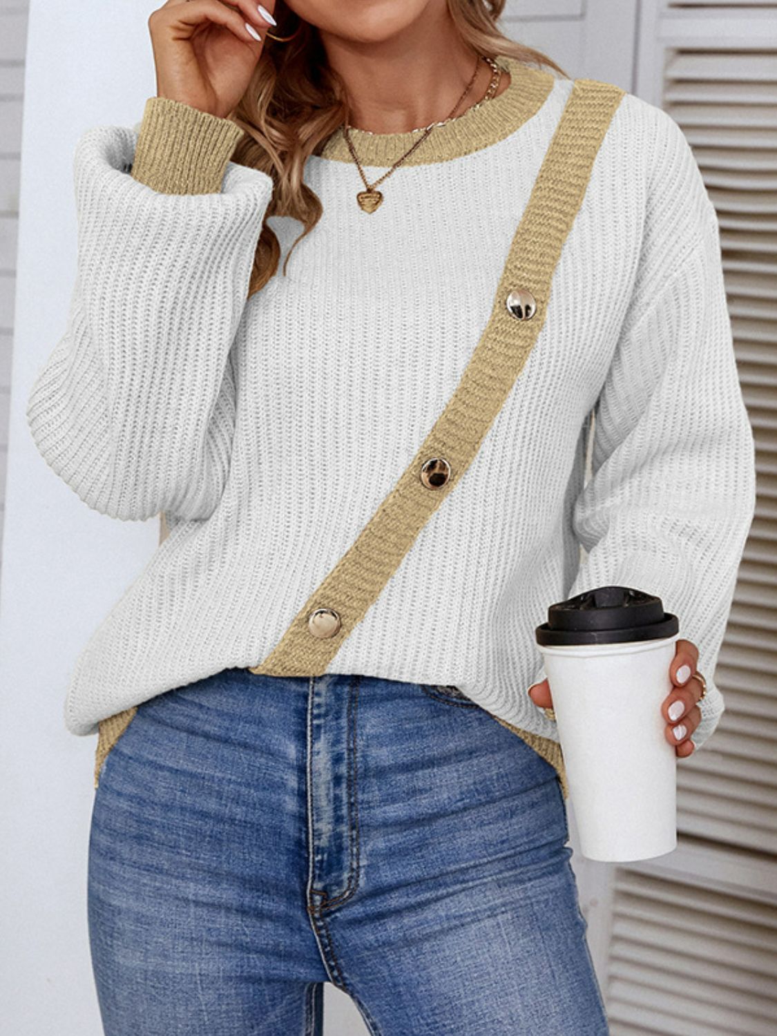 A stylish Contrast Button Detail Rib-Knit Sweater featuring a ribbed texture, round neck, and lantern sleeves, available in multiple colors.