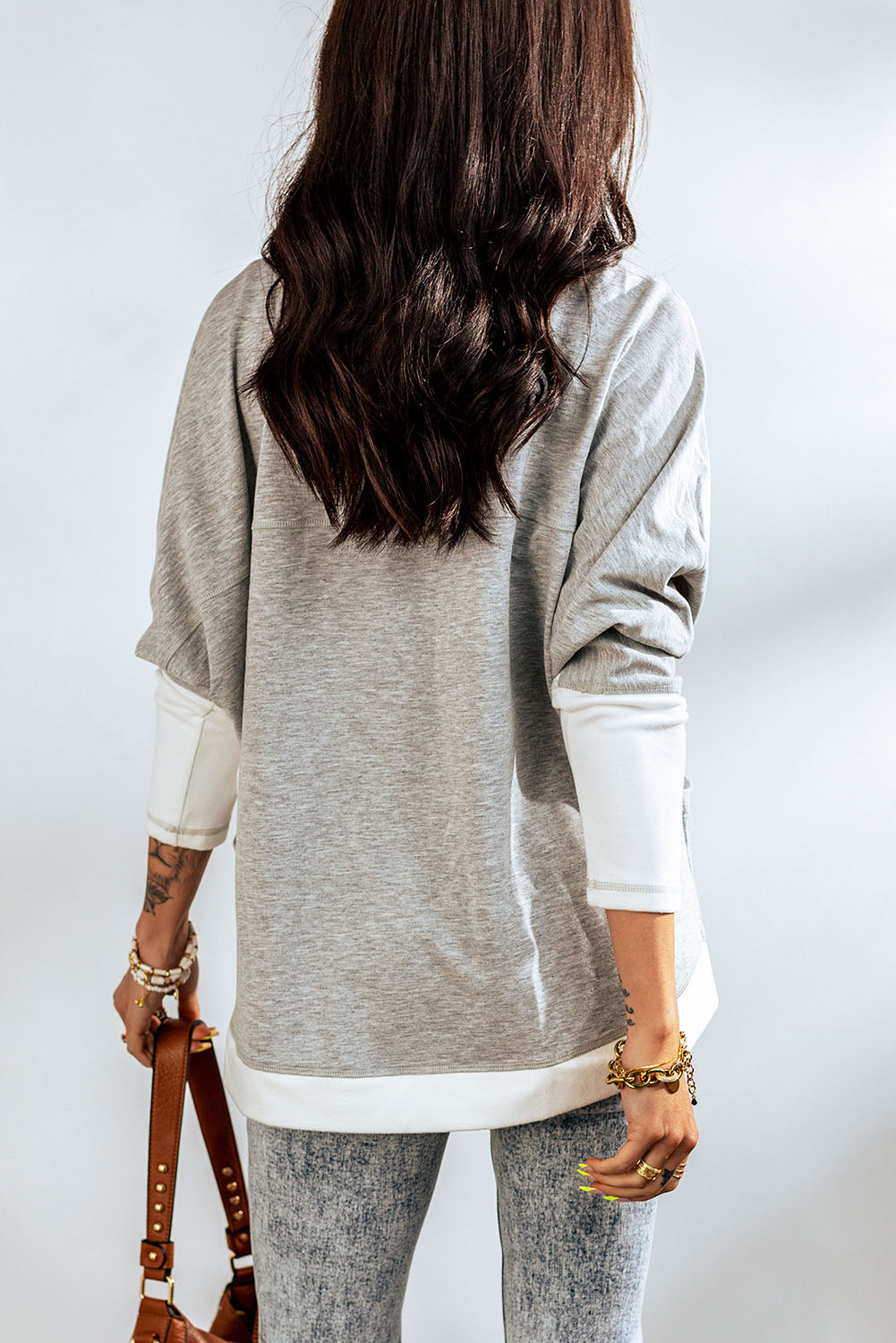 Contrast open front cardigan with pockets, featuring a two-tone design and long dolman sleeves, perfect for casual wear.