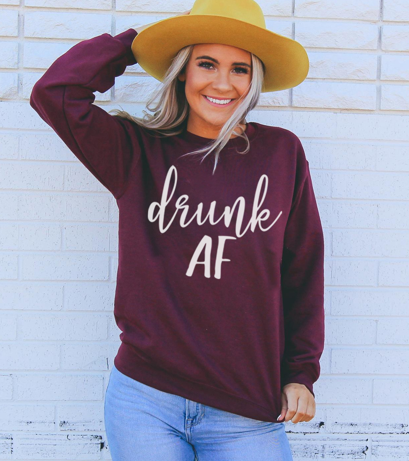 Drunk AF Sweatshirt in a cozy unisex design, featuring a crew neck and soft fabric blend.