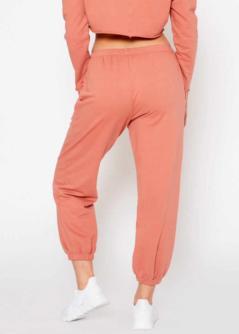 Essential French Terry Sweatpants in Rose with side slit pockets, showcasing a relaxed fit and natural dye.