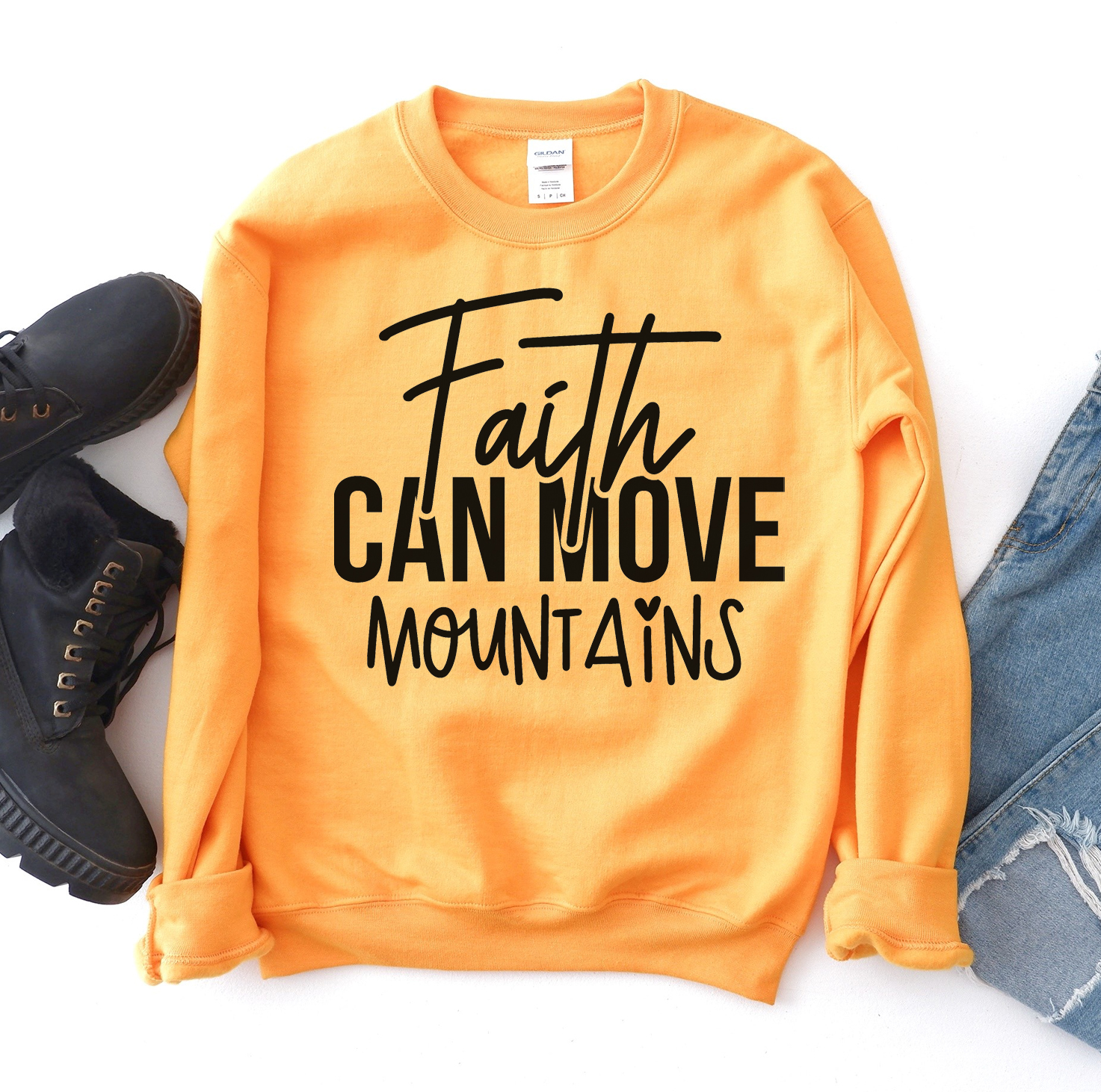 A cozy unisex sweatshirt featuring the phrase 'Faith Can Move Mountains' in stylish lettering, perfect for casual wear.