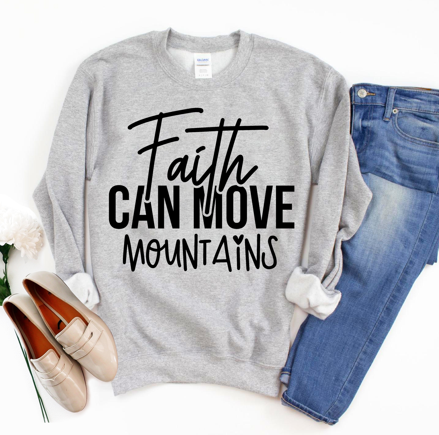 A cozy unisex sweatshirt featuring the phrase 'Faith Can Move Mountains' in stylish lettering, perfect for casual wear.