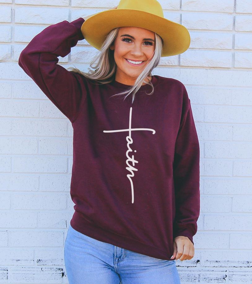 A cozy unisex Faith Sweatshirt featuring a crew neck and soft fabric, perfect for casual wear.