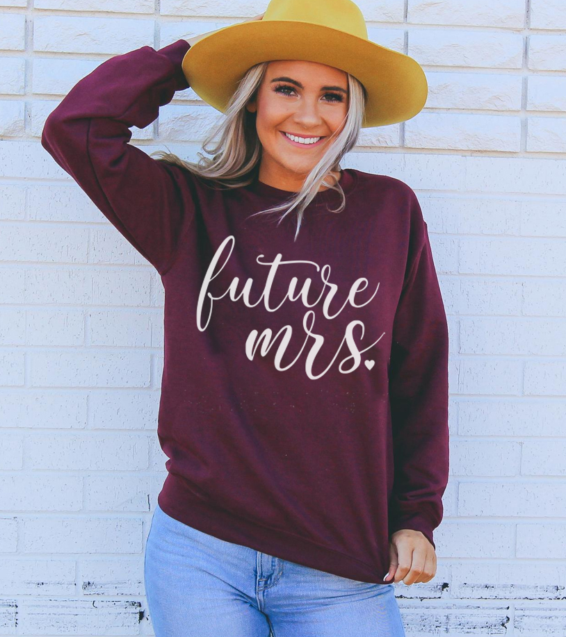 A cozy Future Mrs Sweatshirt in a soft fabric blend, featuring a crew neck and stylish design, perfect for brides-to-be.