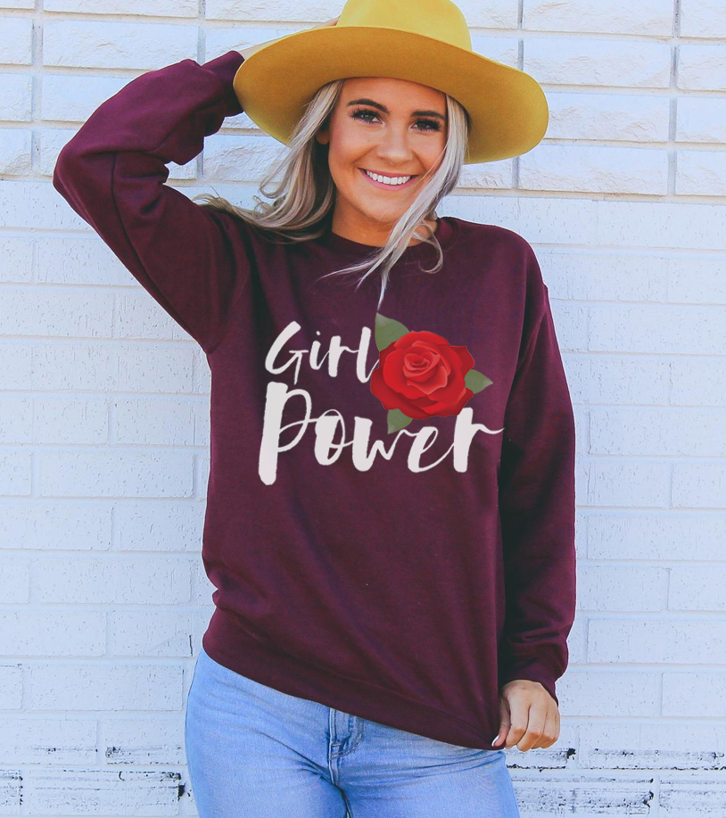 A cozy unisex sweatshirt featuring the empowering 'Girl Power' graphic, made from soft fabric with a classic crew neck design.