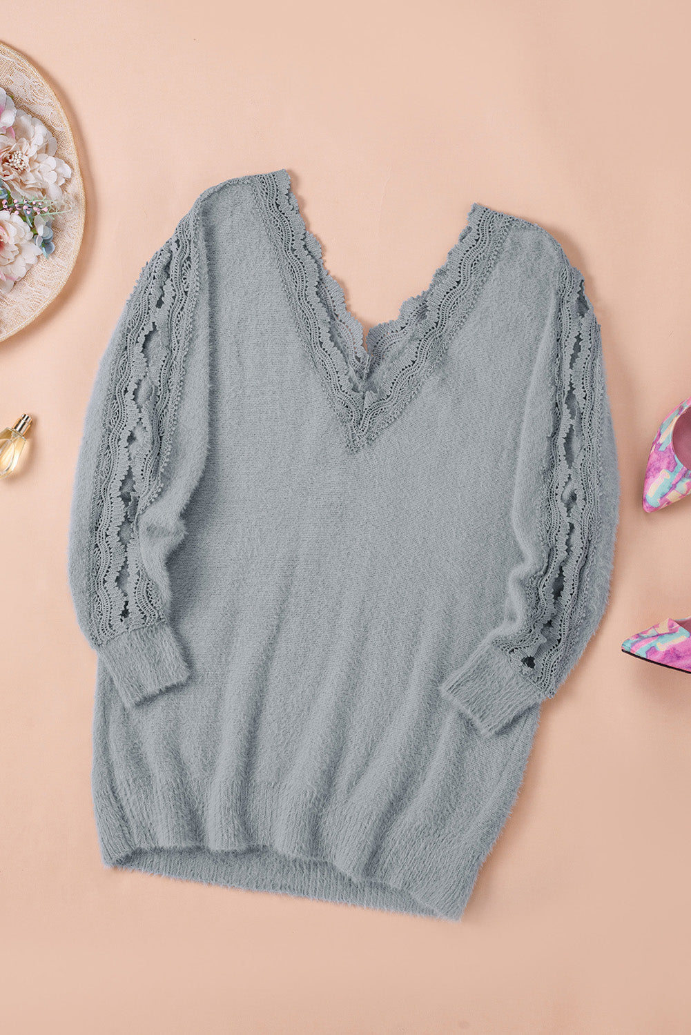 Gray lace splicing sweater featuring a v-neck and long sleeves, showcasing elegant lace details.