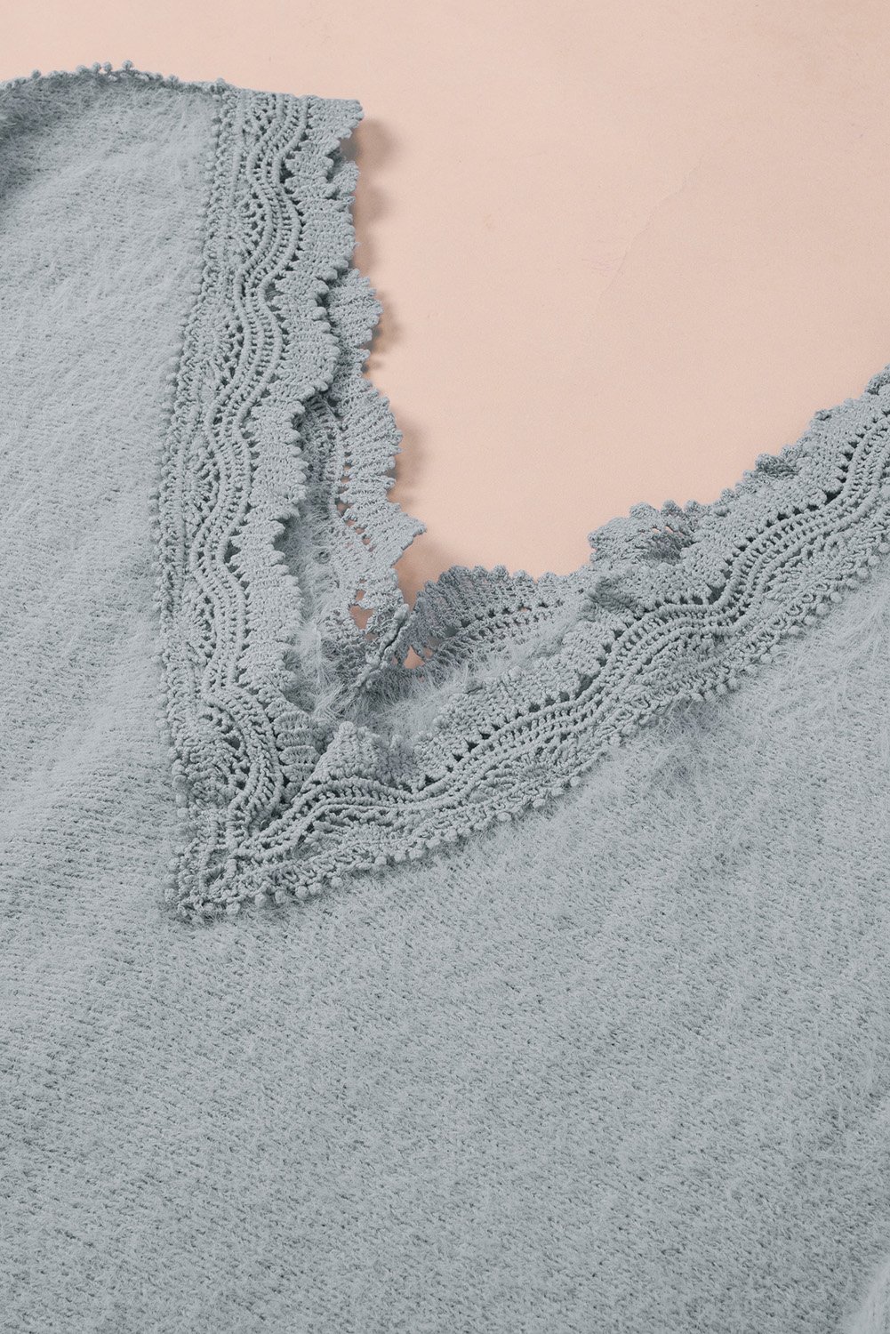 Gray lace splicing sweater featuring a v-neck and long sleeves, showcasing elegant lace details.