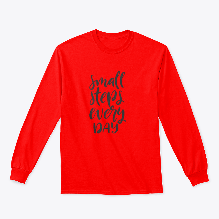 A stylish t-shirt featuring hand-drawn brush pen lettering with the phrase 'Small Steps Every', showcasing a comfortable fit and soft fabric.