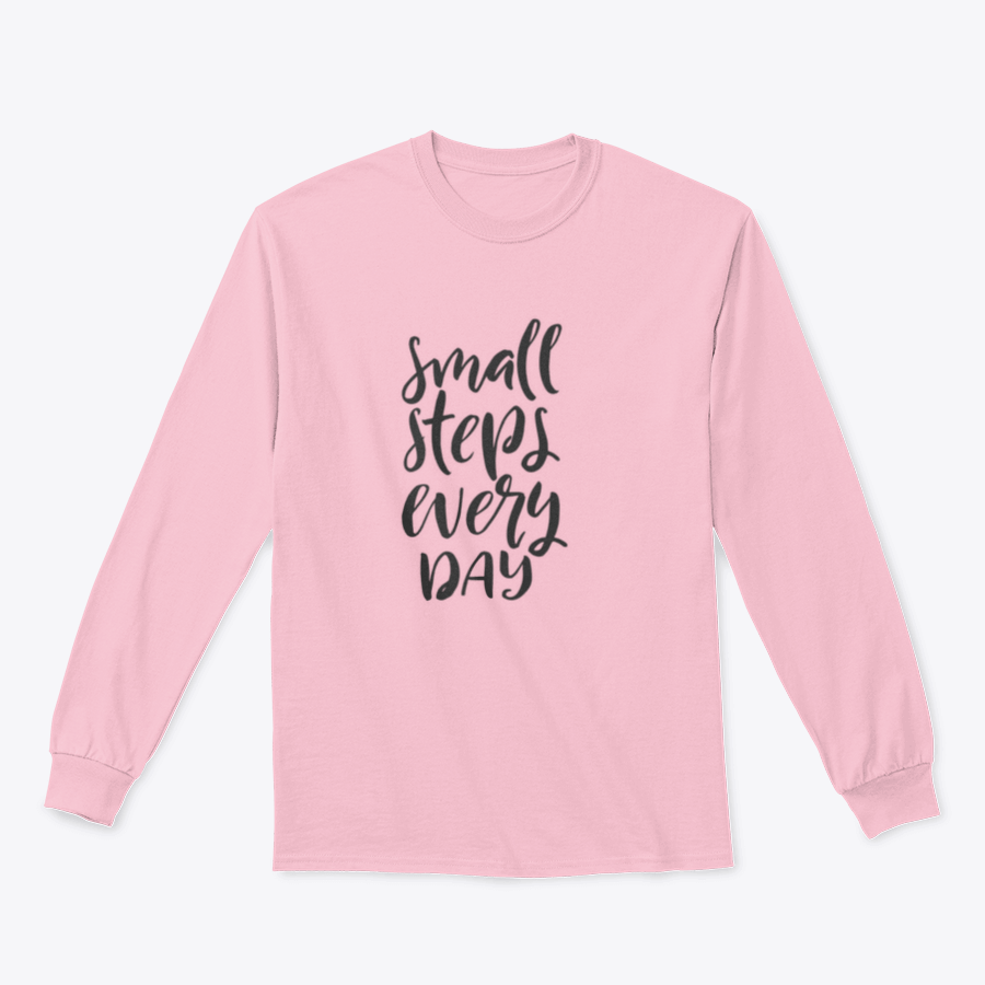 A stylish t-shirt featuring hand-drawn brush pen lettering with the phrase 'Small Steps Every', showcasing a comfortable fit and soft fabric.