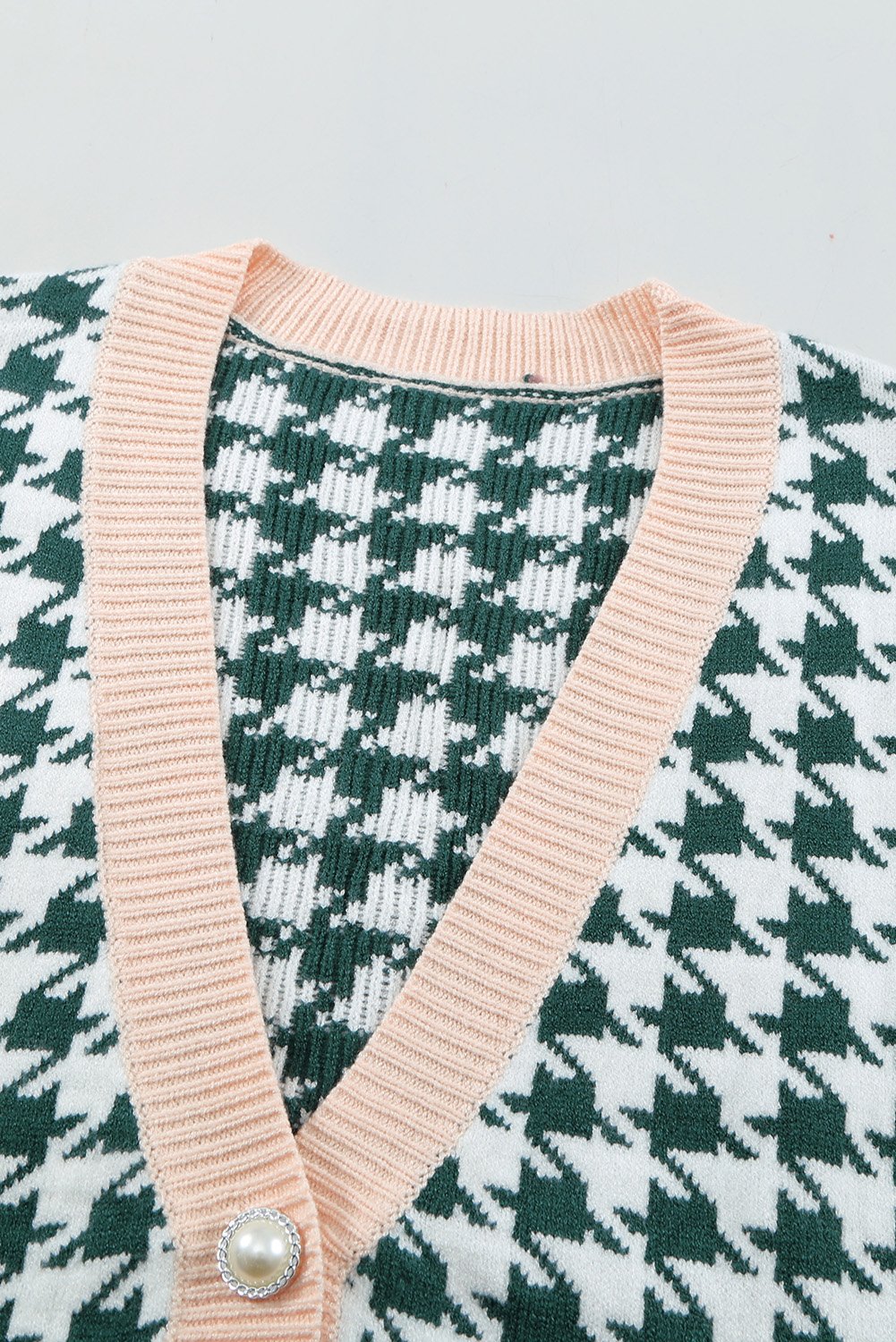 A stylish Houndstooth Vest Cardigan featuring a timeless pattern, button closure, and sleeveless design, available in black, green, and pink.