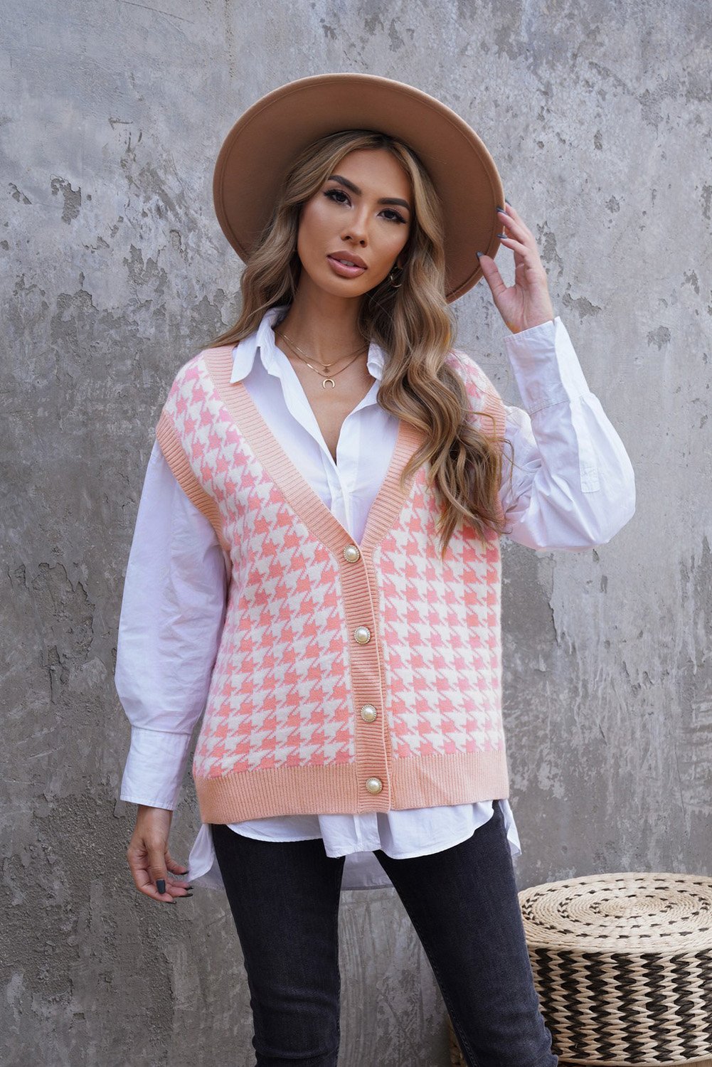 A stylish Houndstooth Vest Cardigan featuring a timeless pattern, button closure, and sleeveless design, available in black, green, and pink.