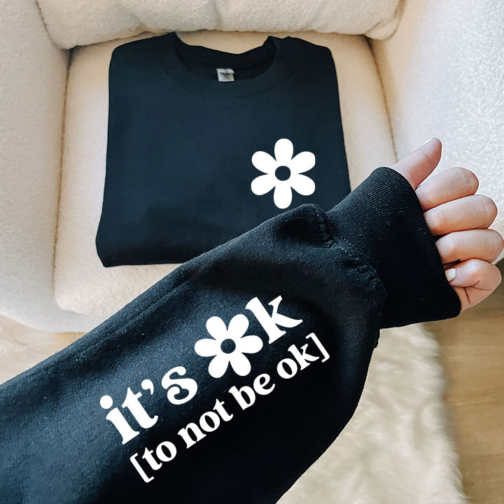 It's Ok to Not Be Ok Crew Neck sweatshirt in black and white print, showcasing a comfortable and stylish design.