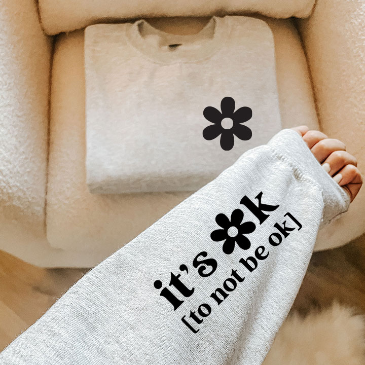 It's Ok to Not Be Ok Crew Neck sweatshirt in black and white print, showcasing a comfortable and stylish design.