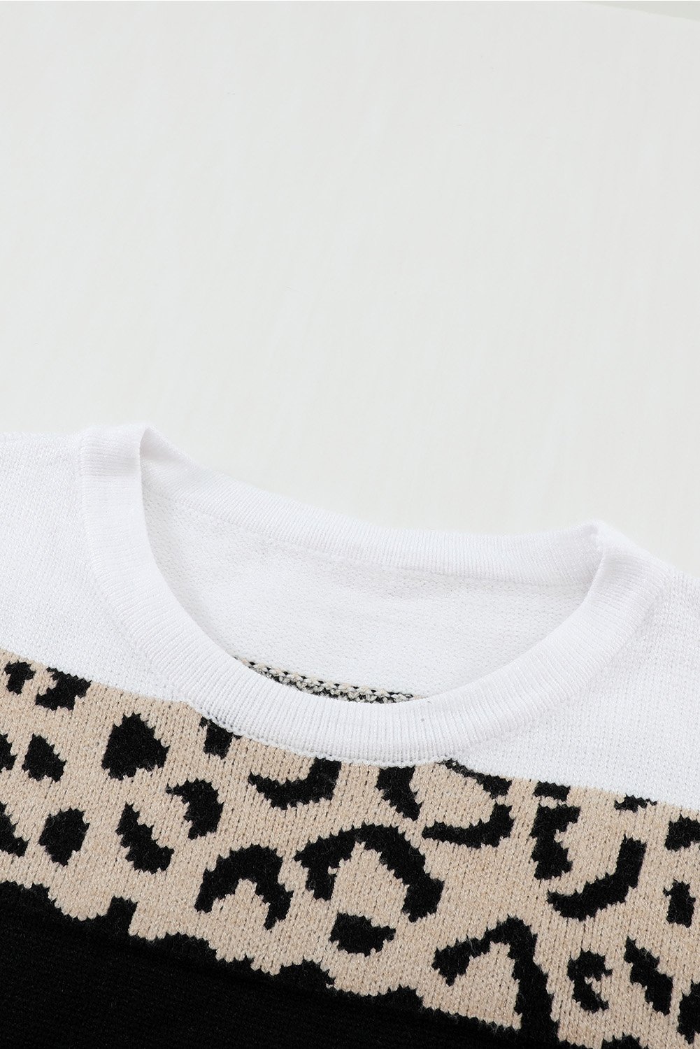 A stylish Knit Pullover Sweater featuring a chic leopard pattern and color block design, perfect for fall and winter wear.